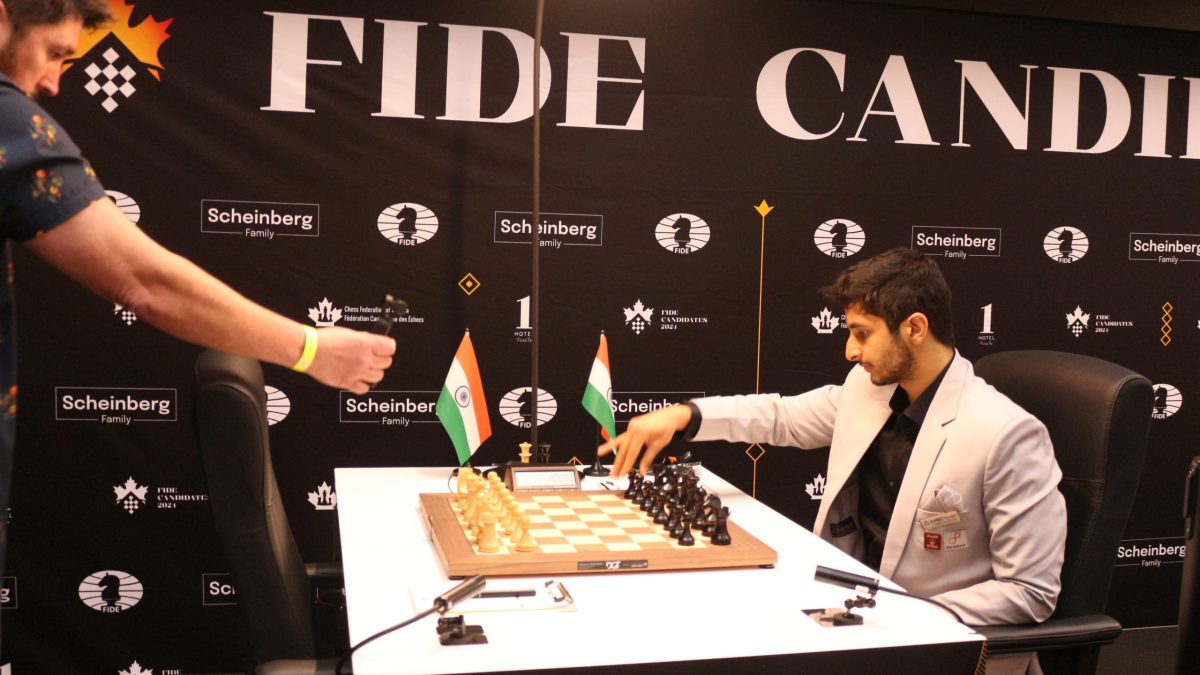 Vidit Gujrathi in a grey suit seated at a chessboard at the Candidates Tournament