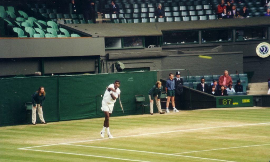 Vijay Amritraj in whites on a grass court at Wimbledon