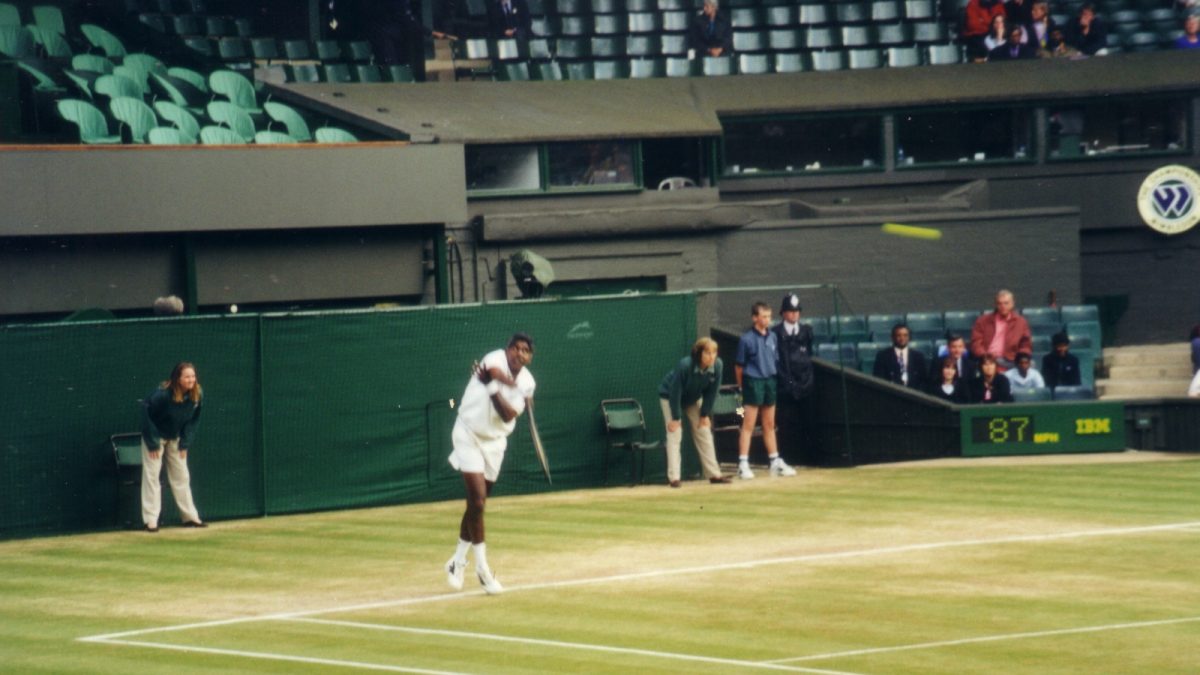 Vijay Amritraj in whites on a grass court at Wimbledon