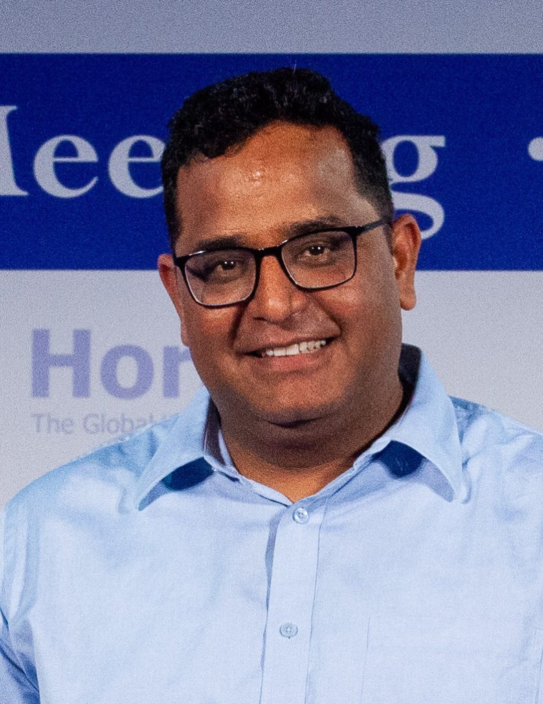 Vijay Shekhar Sharma in glasses and a light blue shirt, smiling