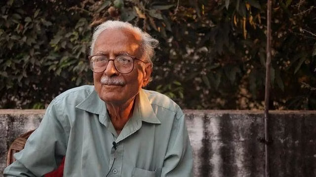Vinod Kumar Shukla seated outdoors at his home