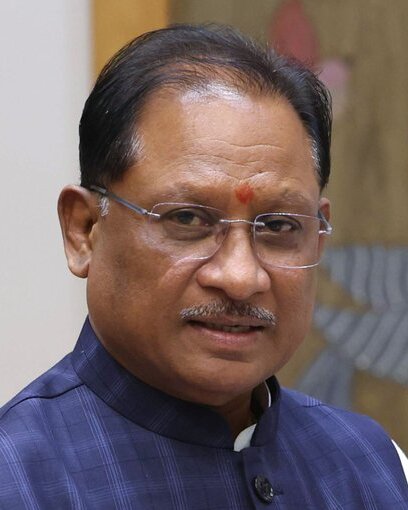 Vishnu Deo Sai in glasses and a blue jacket, smiling