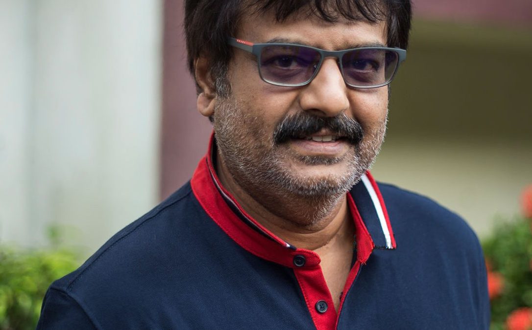 Vivek in tinted glasses and a navy polo shirt