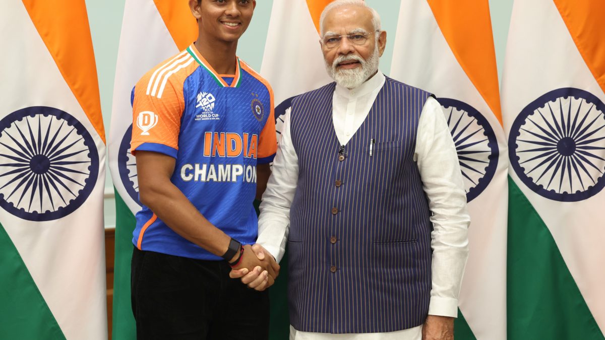 Yashasvi Jaiswal in India's champions jersey shaking hands with Prime Minister Narendra Modi