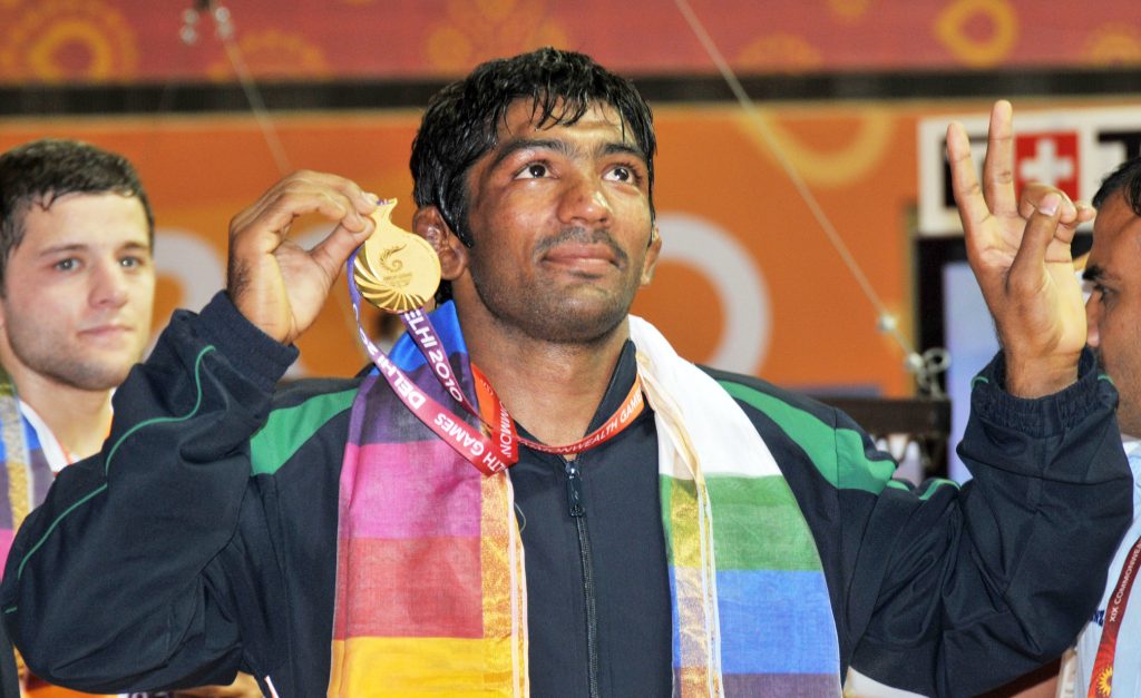 Yogeshwar Dutt holding up his gold medal at the 2010 Commonwealth Games in Delhi
