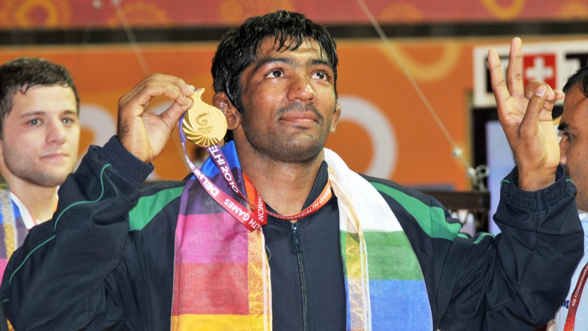 Yogeshwar Dutt holding up his gold medal at the 2010 Commonwealth Games in Delhi